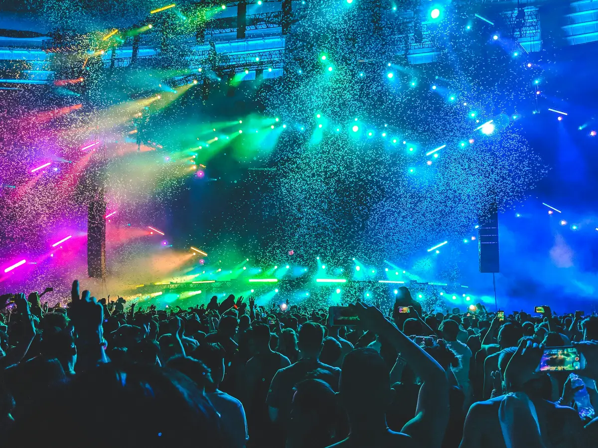 Confetti falling over a packed concert crowd