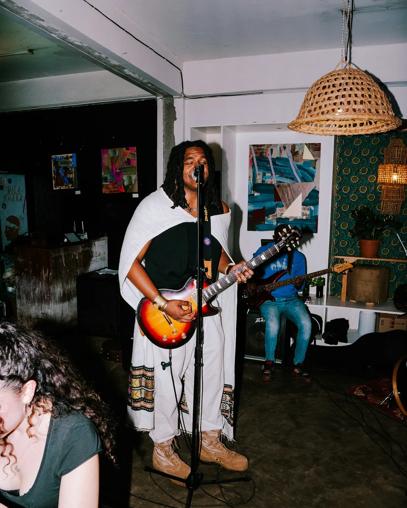 A guitarist playing to a small crowd in Nairobi