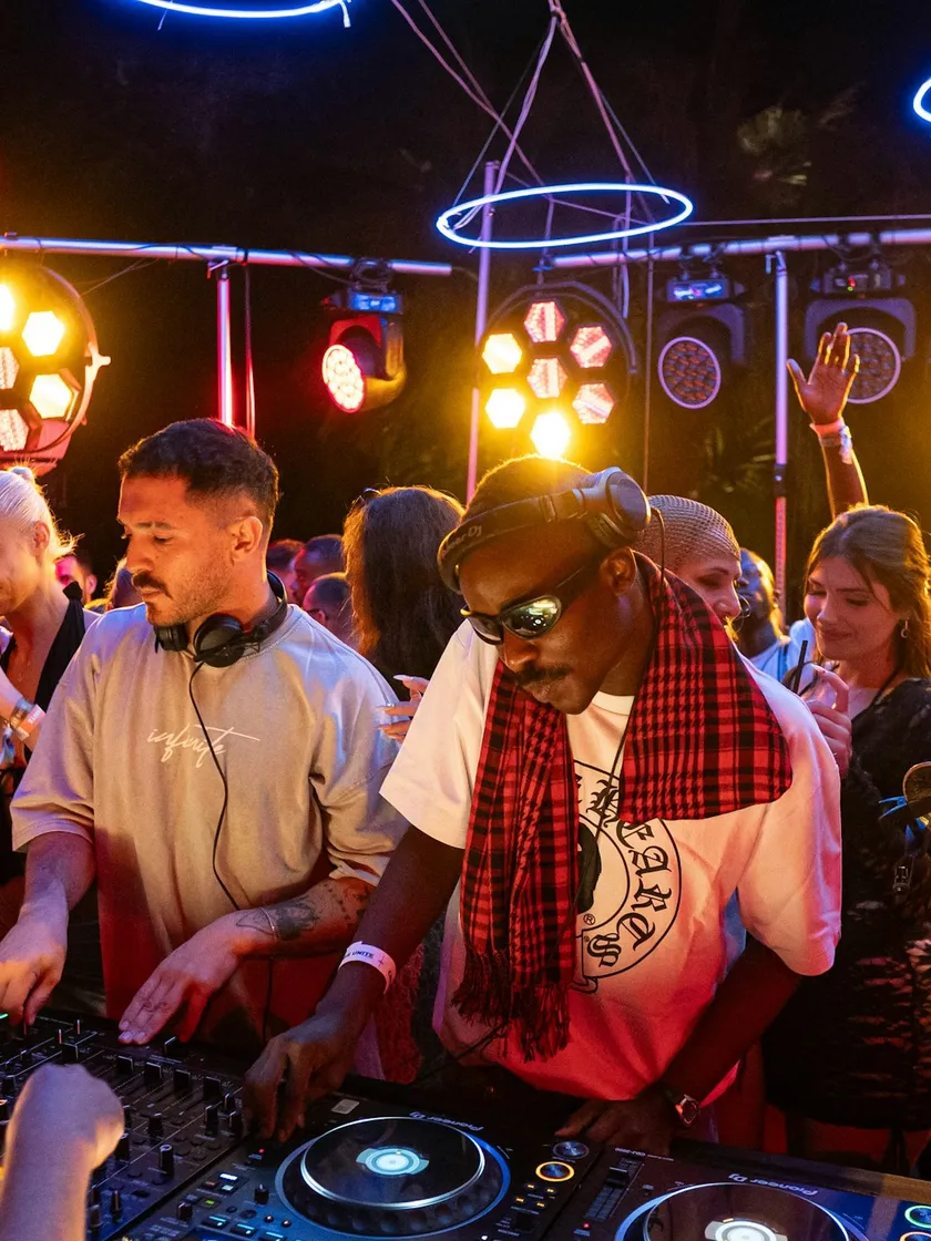 DJs playing to a crowd at an outdoor show